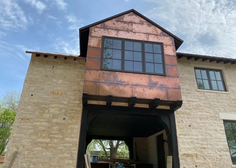 Copper metal panel facade on a stone building for Skylight Installation in Elko